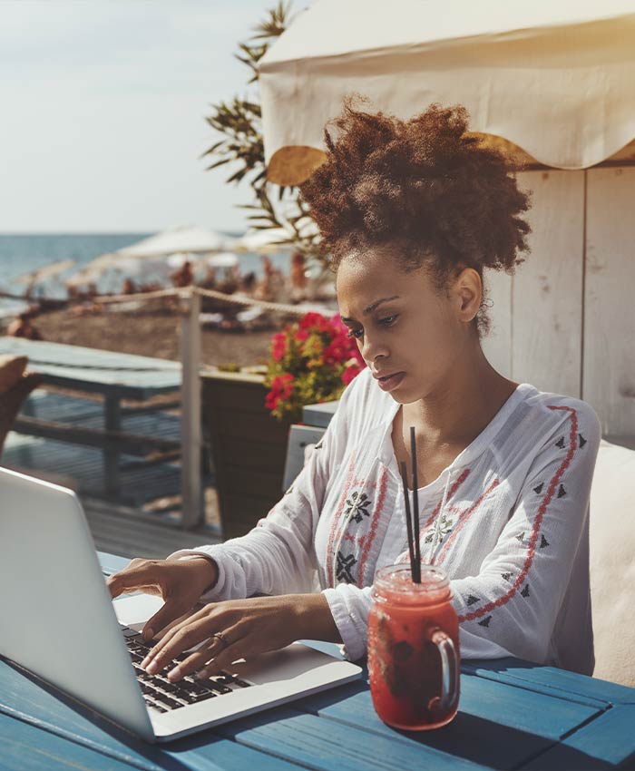woman-typing-in-front-of-Tropical-leaves-2